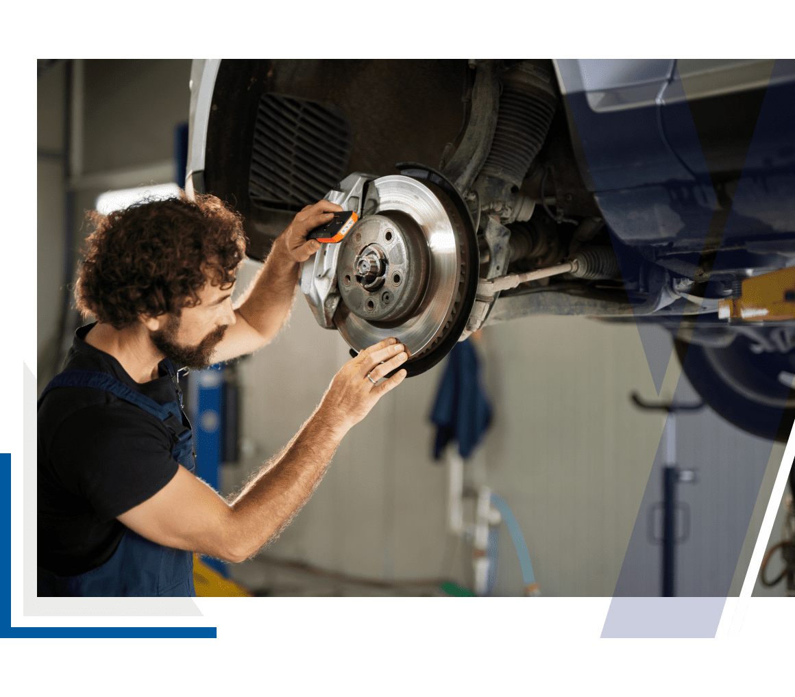Mechanic inspecting car brake system